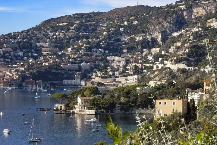 Scenic coastal view of Nice, France, highlighting vibrant hillside architecture and serene Mediterranean waters.