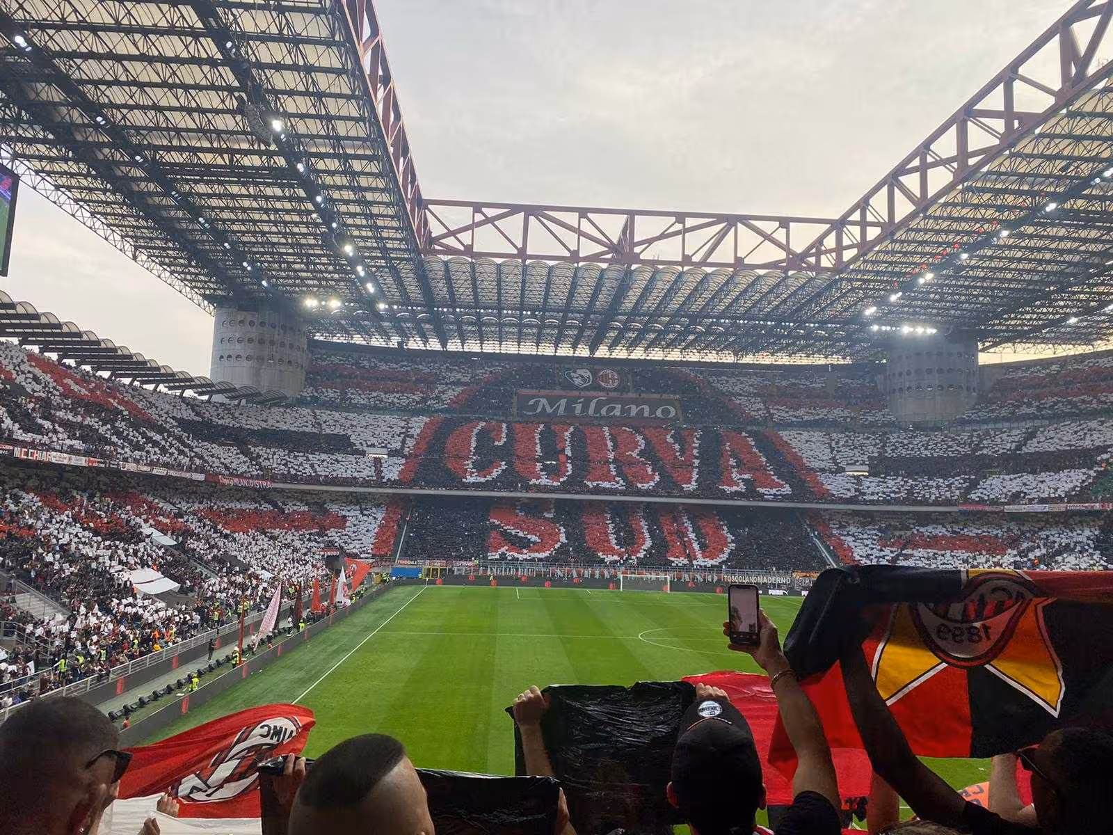 San Siro stadium tifo and flags during a Milan football match, live fan experience with local supporters