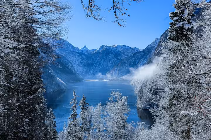 Scenic winter view of snow-covered mountains and lake en route from Milan to St. Moritz private transfer.