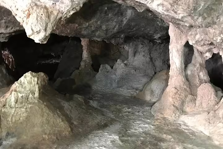 A stunning view inside Milatos Cave, highlighting the intricate limestone formations and mysterious dark crevices.