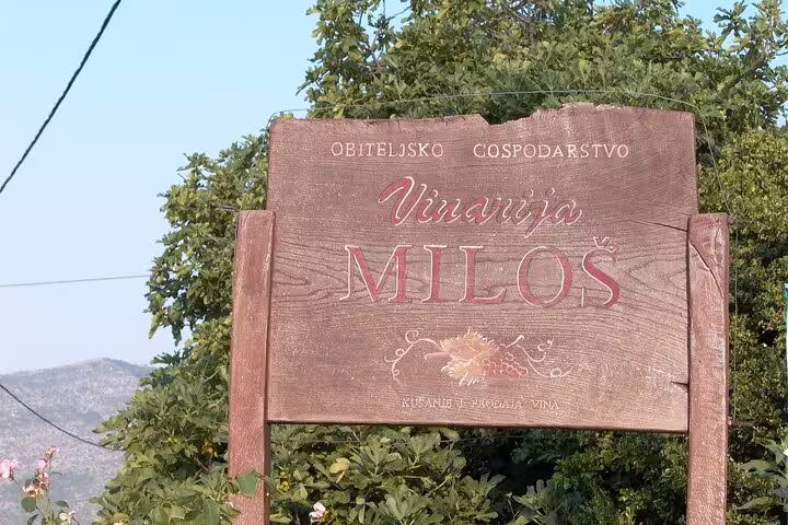 Wooden sign for Miloš winery on Pelješac Peninsula, featured on a private Dubrovnik wine tour