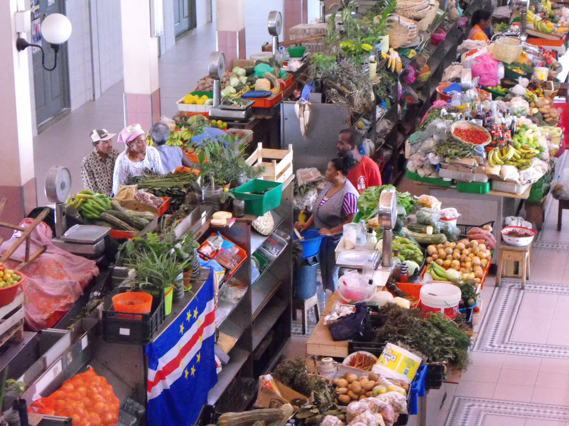 Colorful market scene in Mindelo, São Vicente, showcasing local produce and vibrant culture on a half-day tour.