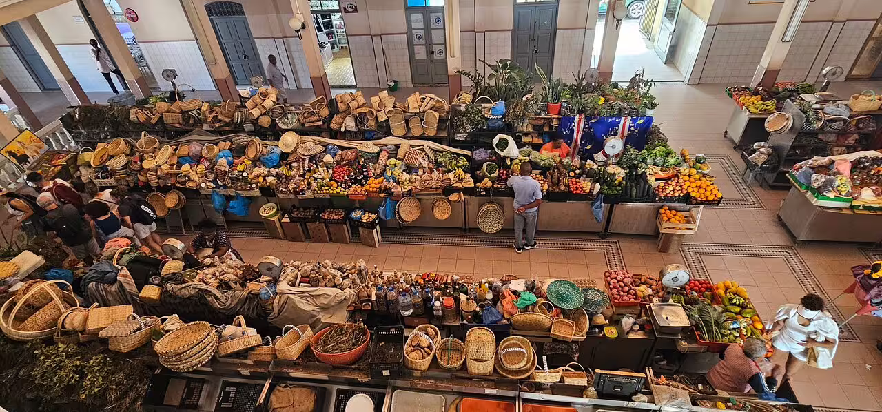 Vibrant market scene in Mindelo, São Vicente, showcasing local produce and baskets, perfect for a half-day shore excursion.