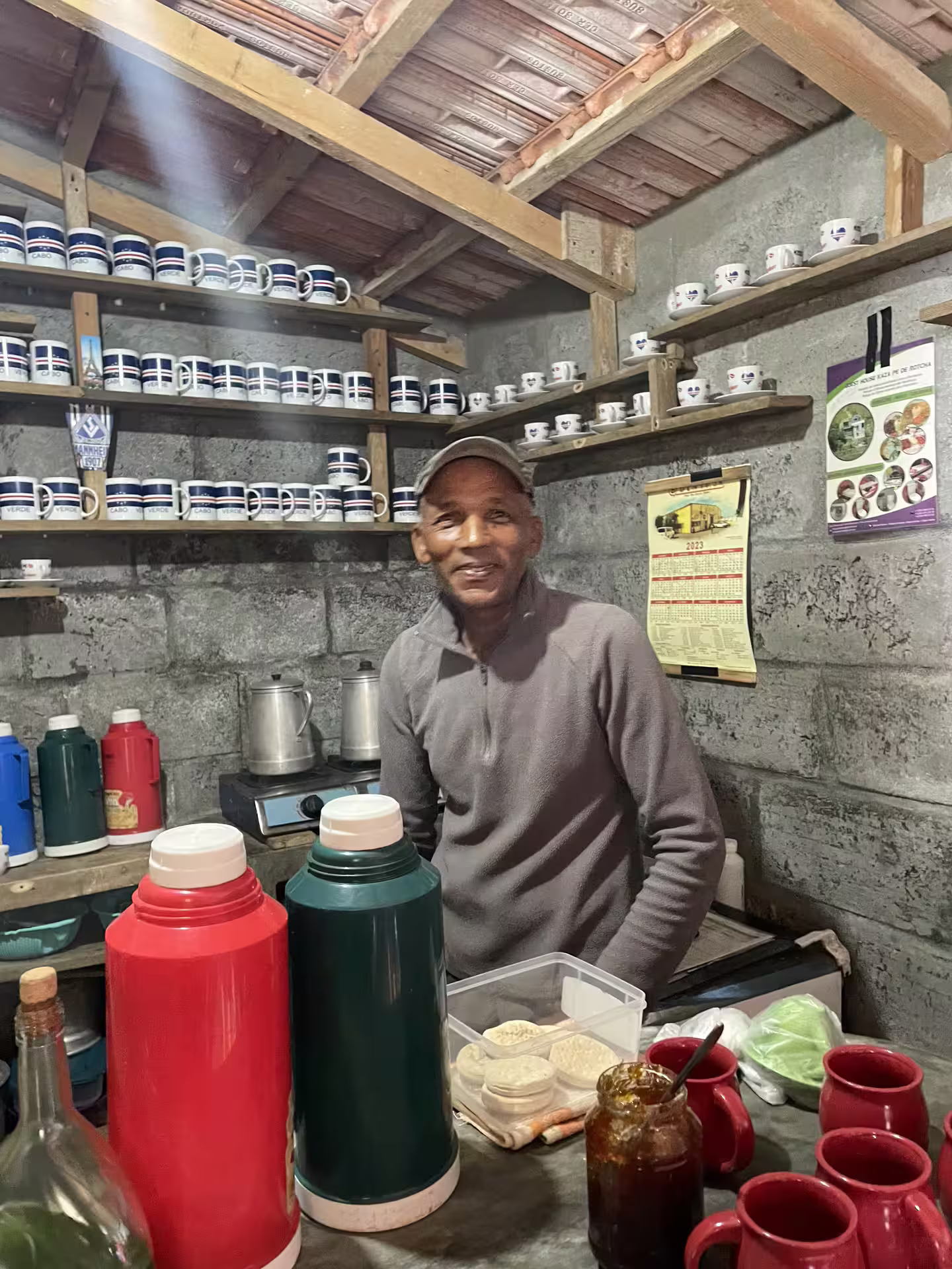 Local vendor in Mindelo, São Vicente, offering traditional drinks during a full-day shore excursion highlighting cultural experiences.