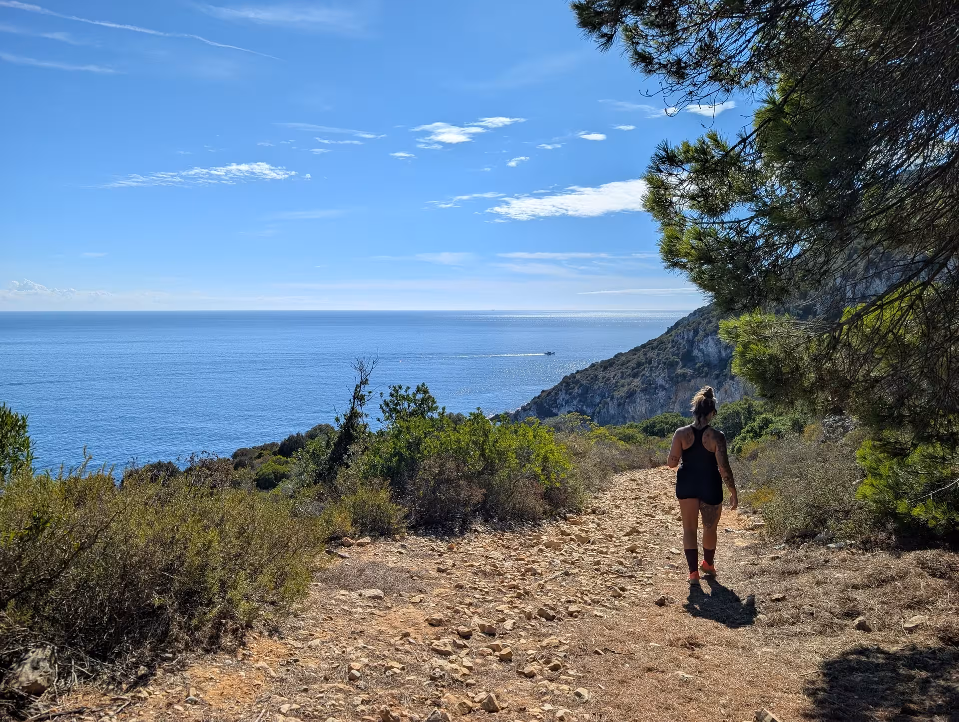 Hiker on scenic coastal path with panoramic sea views on mindful coastal hike, peaceful nature walk