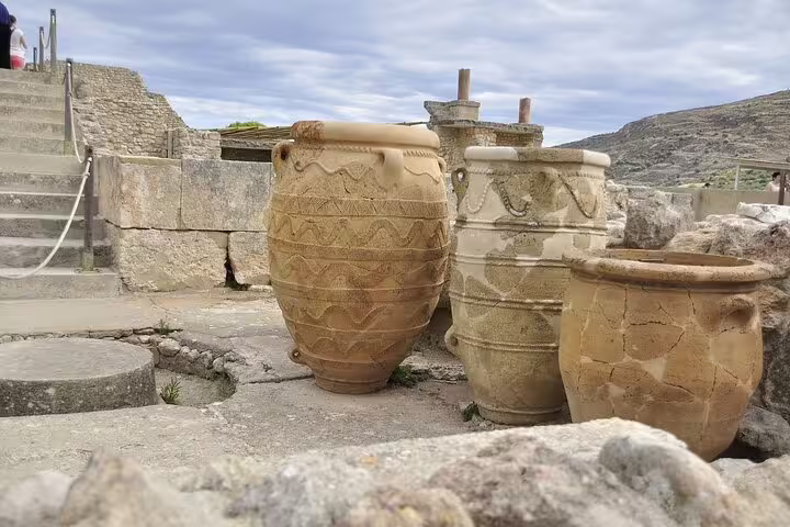 Ancient ceramic jars at Knossos Palace, Crete, showcasing Minoan culture on a private tour of the archaeological site.