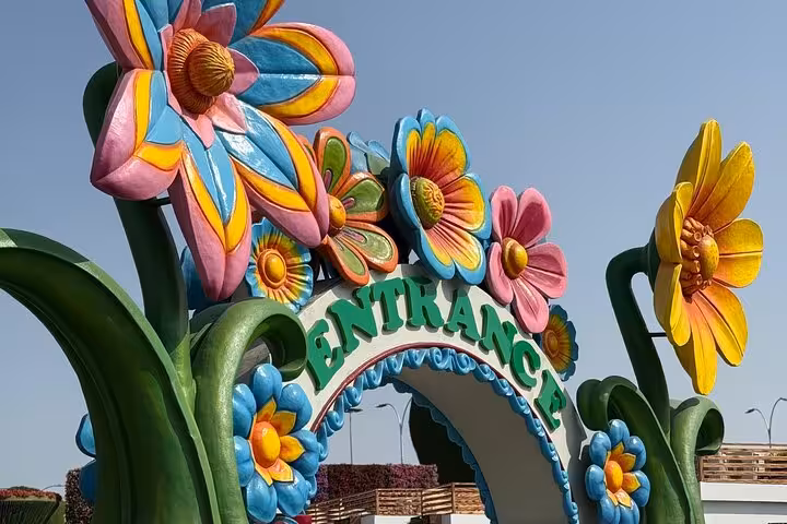Close-up of vibrant flower-themed entrance arch at Dubai Miracle Garden, Fujairah pickup and transport included