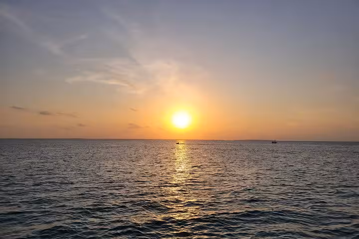 Breathtaking sunset over the Indian Ocean, a highlight of the Mnemba Island Dolphin & Snorkeling Tour in Zanzibar.