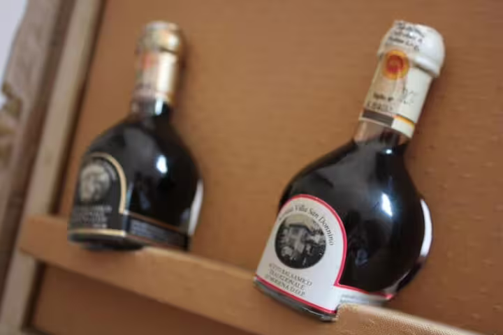 Traditional Modena balsamic vinegar bottles displayed during private tasting on Ferrari Museum and vinegar cellar tour