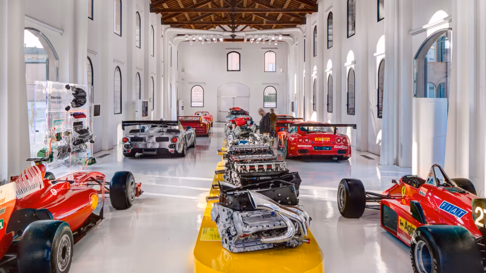 Modena Enzo Ferrari Museum hall with race cars and engine display, part of Maranello combo ticket package