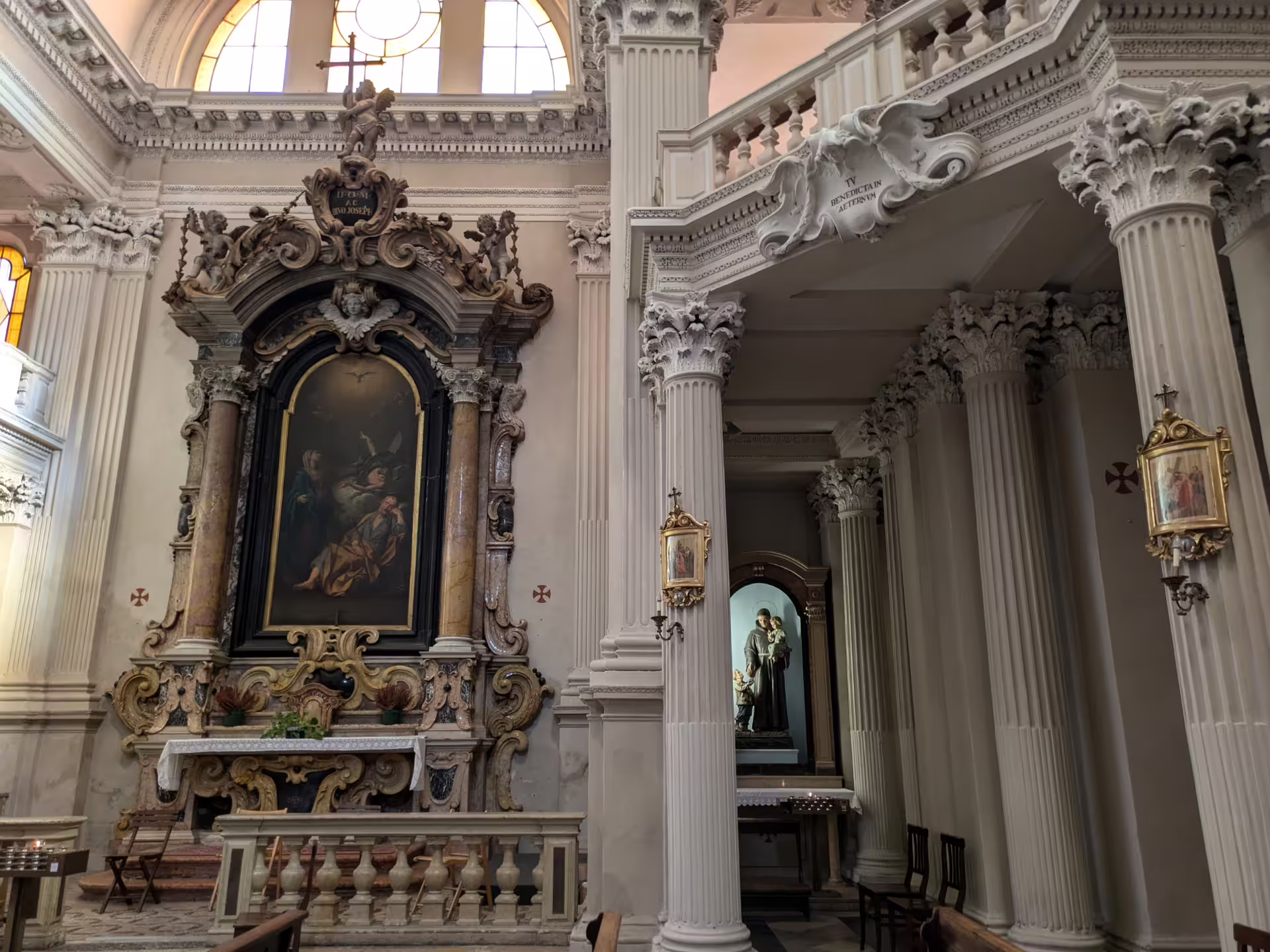 Ornate interior of a historic Modena church with intricate columns and religious art, featured on the sightseeing tour.