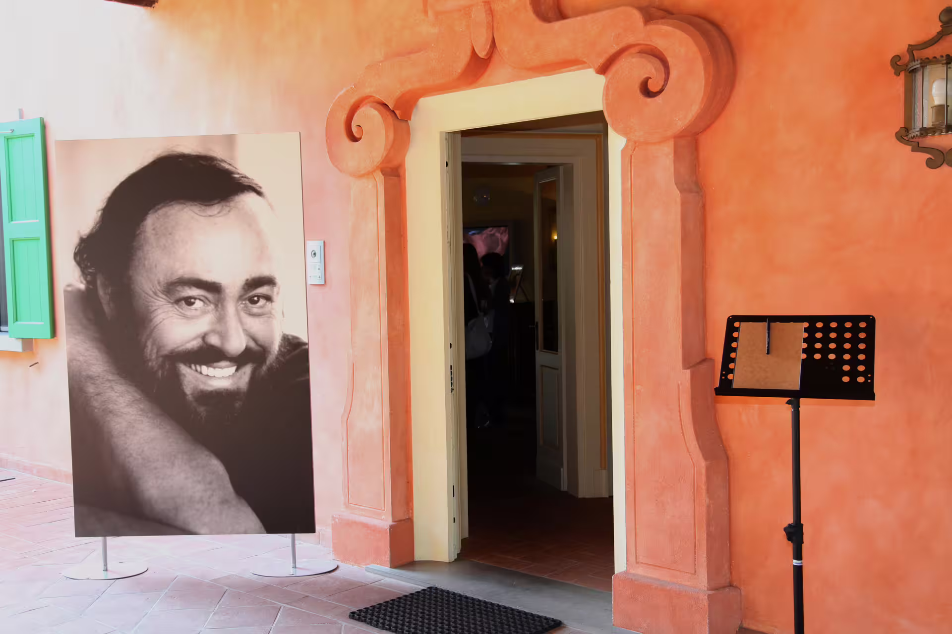 Entrance to Casa Museo Luciano Pavarotti near Modena with portrait display, included in Ferrari combo tour