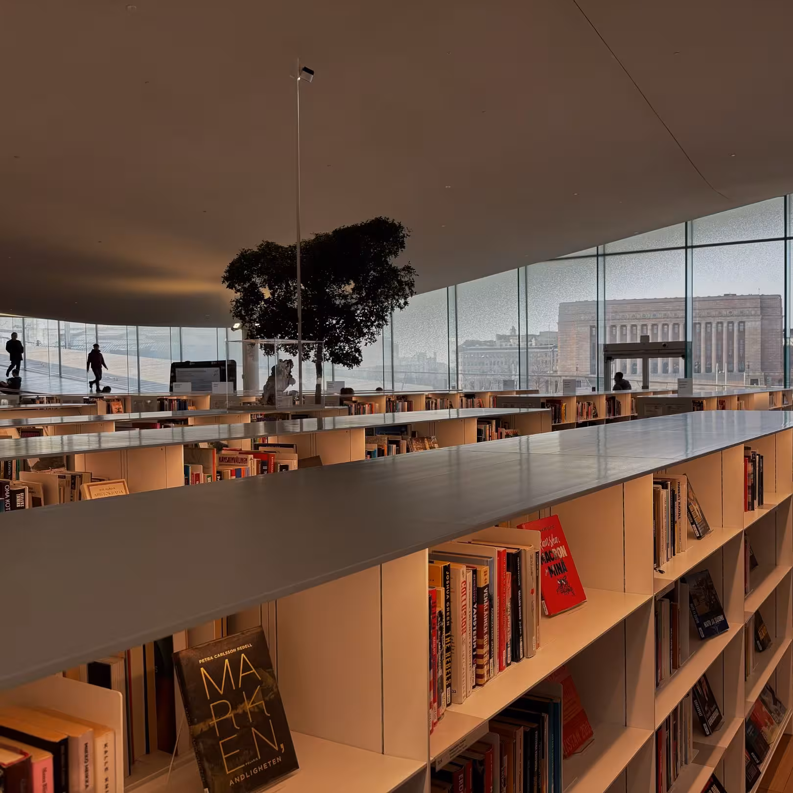 Modern library interior with panoramic windows and book-filled shelves, a must-see on architecture tours.