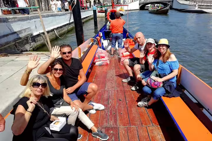 Tourists enjoy a scenic Moliceiro boat cruise along Aveiro's canals, highlighting the charm of Portugal's 'Venice'.