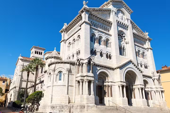 Elegant exterior of Monaco's cathedral under a clear blue sky, showcasing historic architecture on a private tour.