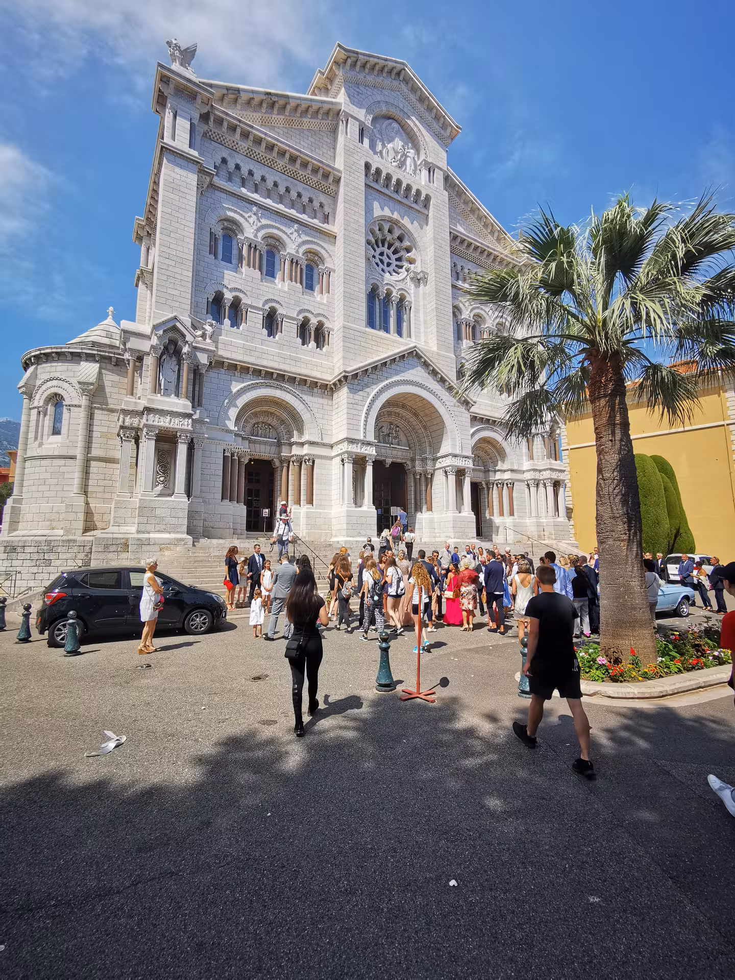 Monaco Cathedral facade with visitors under blue sky, stop on Marseille shore excursion to Nice, Eze and Monaco