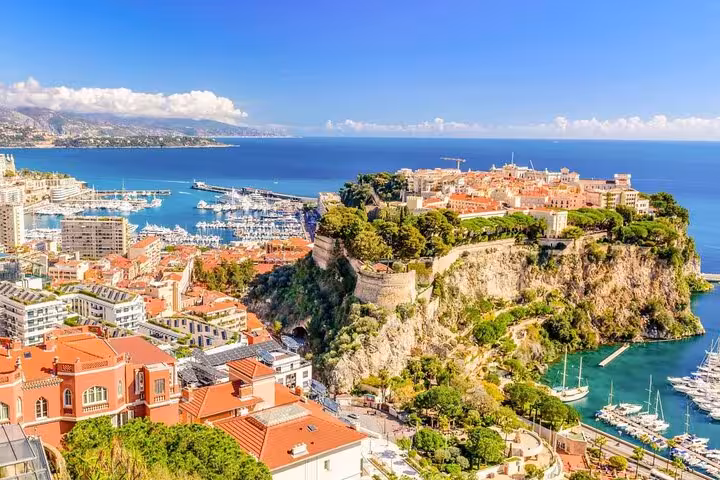 Aerial view of Monaco's picturesque coastline with historic architecture and vibrant marina.
