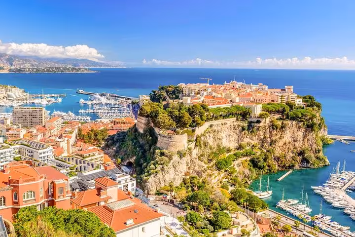 Scenic view of the Monaco coastline with yachts and historic architecture, ideal for private guided tours.