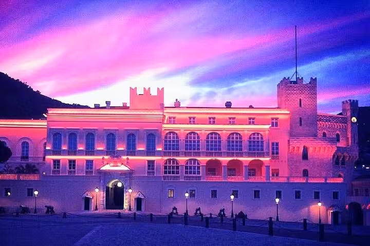 Monaco's Prince's Palace illuminated against a stunning sunset, featured on the Italy, France, Monaco tour.