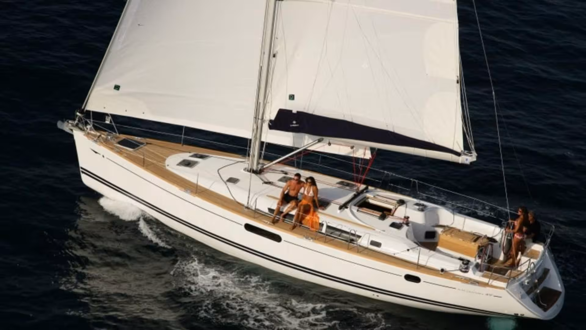 Elegant sailing boat with tourists enjoying La Maddalena Archipelago cruise from Cannigione under full sail.