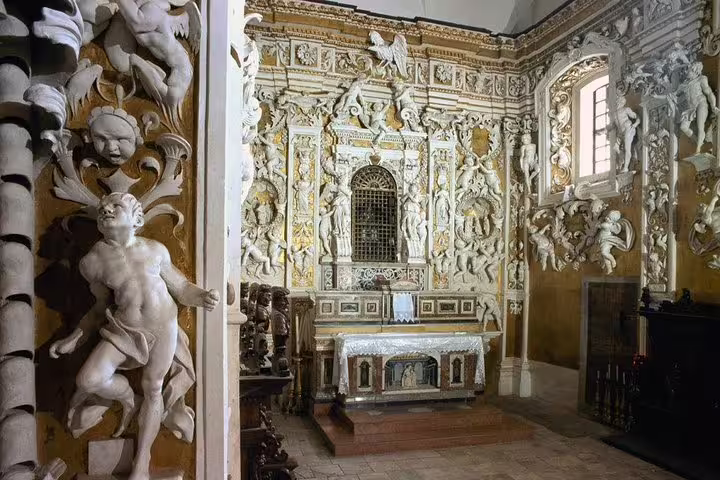Baroque chapel interior in Monreale near Palermo with richly carved stucco angels and ornate altar visited on guided day trip