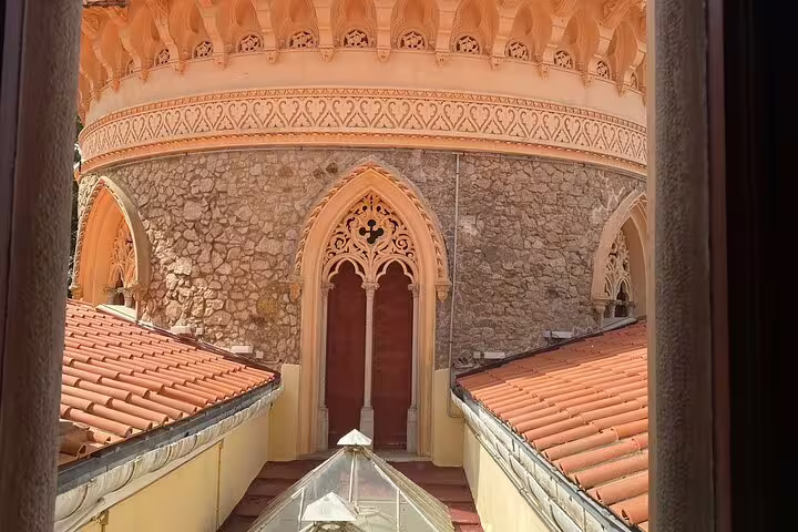 Close-up of Monserrate Palace's gothic arch and stone facade, highlighting unique architectural details in Sintra.