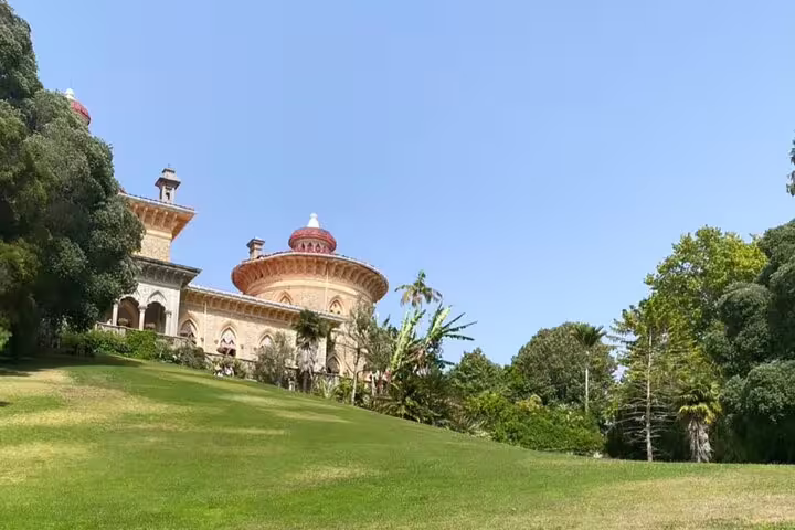 View of Monserrate Palace's stunning architecture set against lush gardens in Sintra on a clear day.