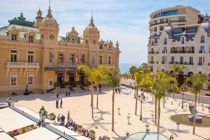 Elegant Monte Carlo Casino in Monaco with palm-lined plaza, featured in French Riviera private shore excursion.