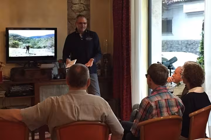 Guests listen to a historical presentation about Monte Cassino, enhancing the cultural experience of the Gustav Wine tour.