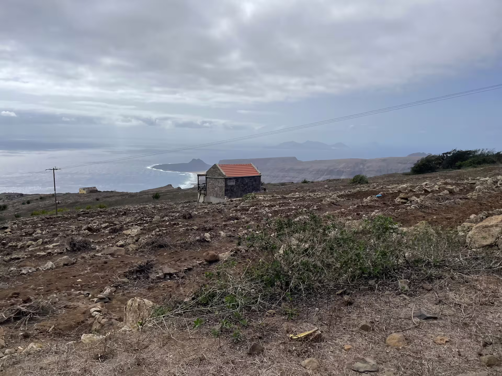 Scenic view of rugged terrain and ocean horizon from Monte Verde, São Vicente, highlighting adventure and hiking opportunities.