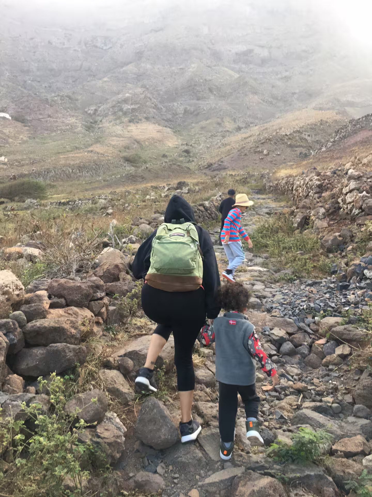 Hikers traverse the rocky trails of Monte Verde in São Vicente, surrounded by stunning mountain landscapes and lush greenery.