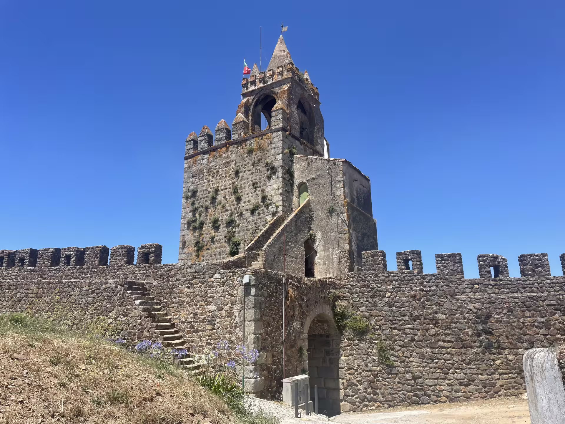 Visit the historic Montemor-o-Novo Castle under a clear blue sky on the Évora or Montemor beekeeping tour.