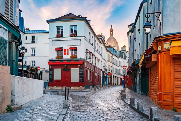 Quiet cobblestone street in Montmartre Paris, route for street art walking tour and French apéritif tasting