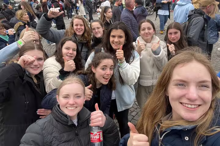 Friends posing with thumbs up in Montmartre during a Paris self-guided scavenger hunt walking tour