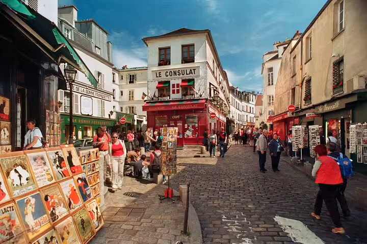 Busy Place du Tertre by Le Consulat in Montmartre, Paris street art walking tour with French drink tasting