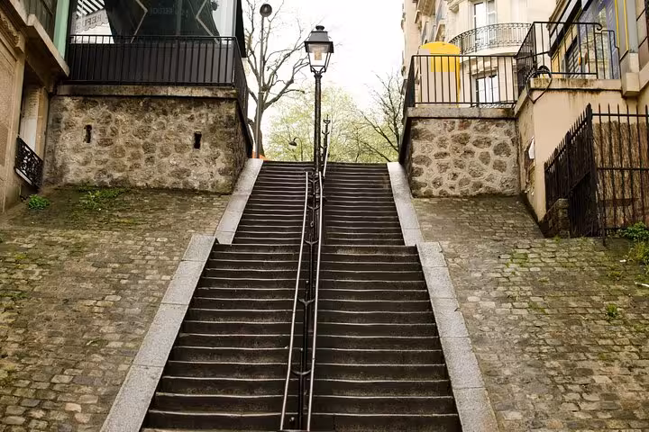Montmartre stone stairway in Paris, scenic stop on street art walking tour with French drink tasting