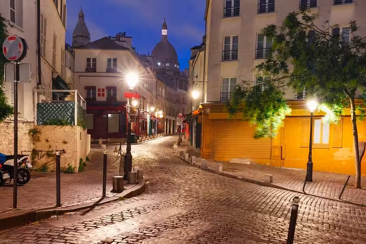 Evening cobblestone street in Montmartre near Sacré-Cœur, perfect for Paris street art walking tour