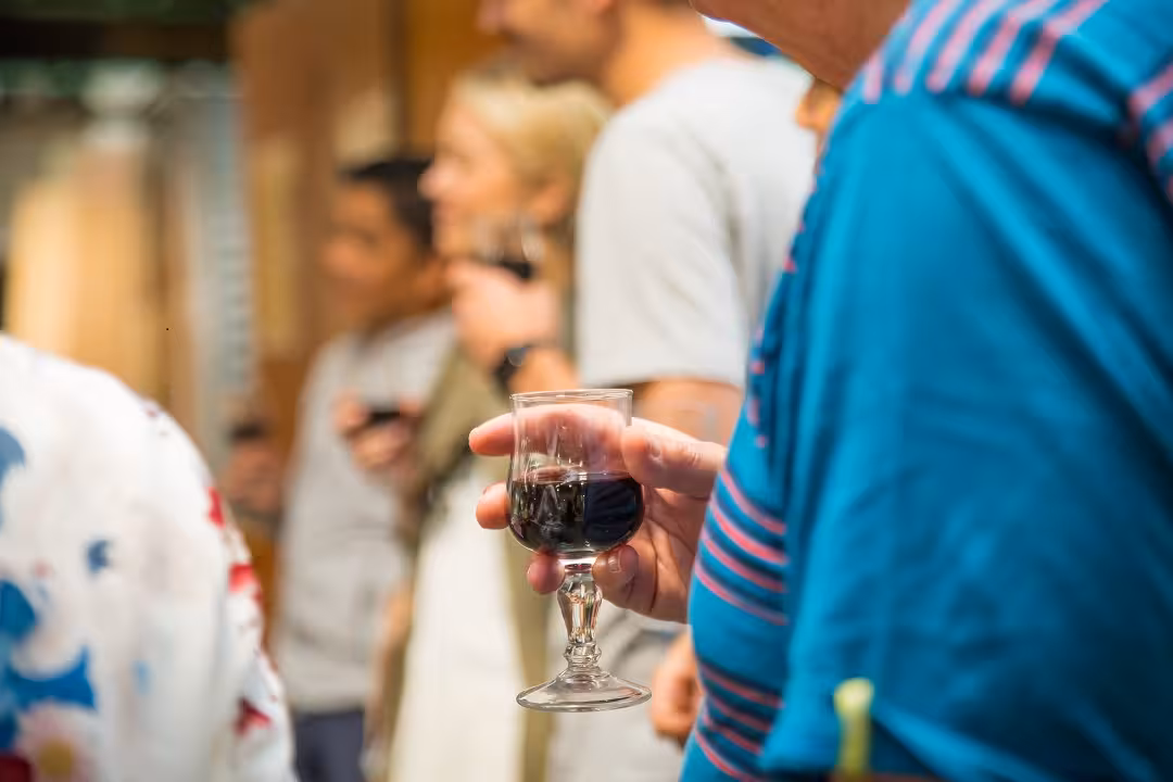 Tour participant enjoying a glass of red wine during the Montmartre aperitif and wine tasting walking tour.