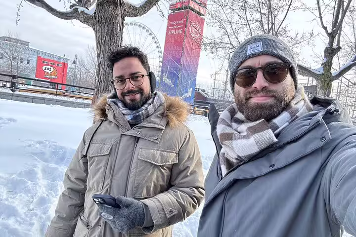 Winter selfie on Montréal scavenger hunt walking tour near Old Port Ferris wheel and snowy waterfront