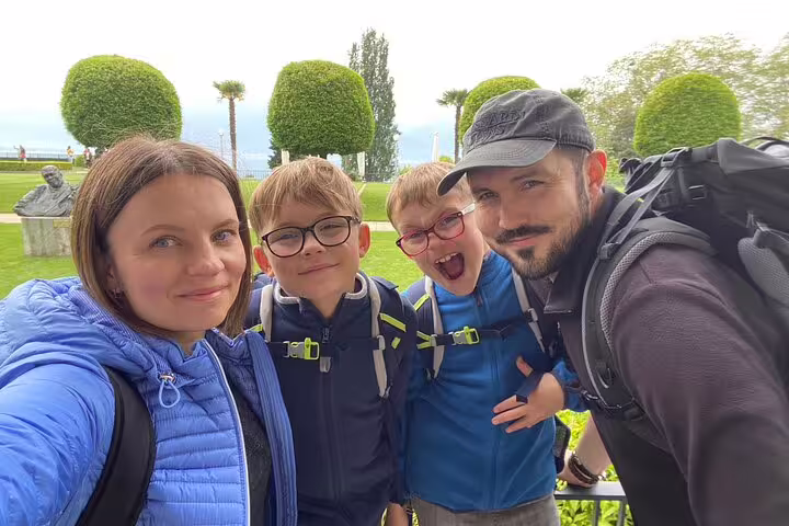 Family selfie in lakeside Montreux park during a self-guided scavenger hunt tour, Swiss Riviera sights