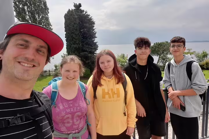 Friends group photo in Montreux with Lake Geneva view, enjoying a self-guided scavenger hunt and sights tour