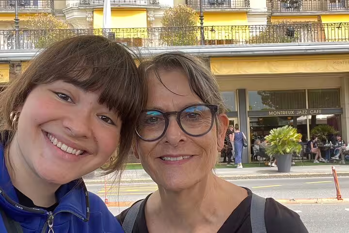 Smiling travelers by Montreux Jazz Cafe during a Montreux self-guided scavenger hunt and sightseeing tour