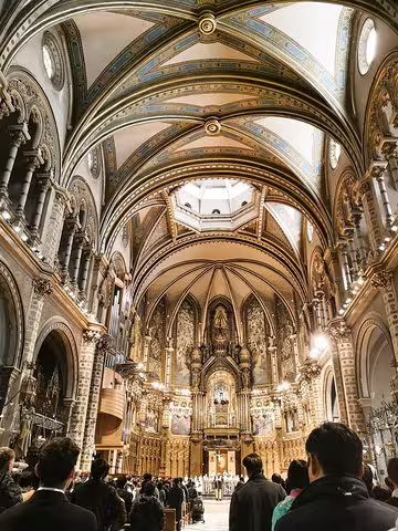 Stunning interior view of Montserrat Basilica during a private tour, showcasing intricate architecture before enjoying Penedes winery lunch and wine tasting.