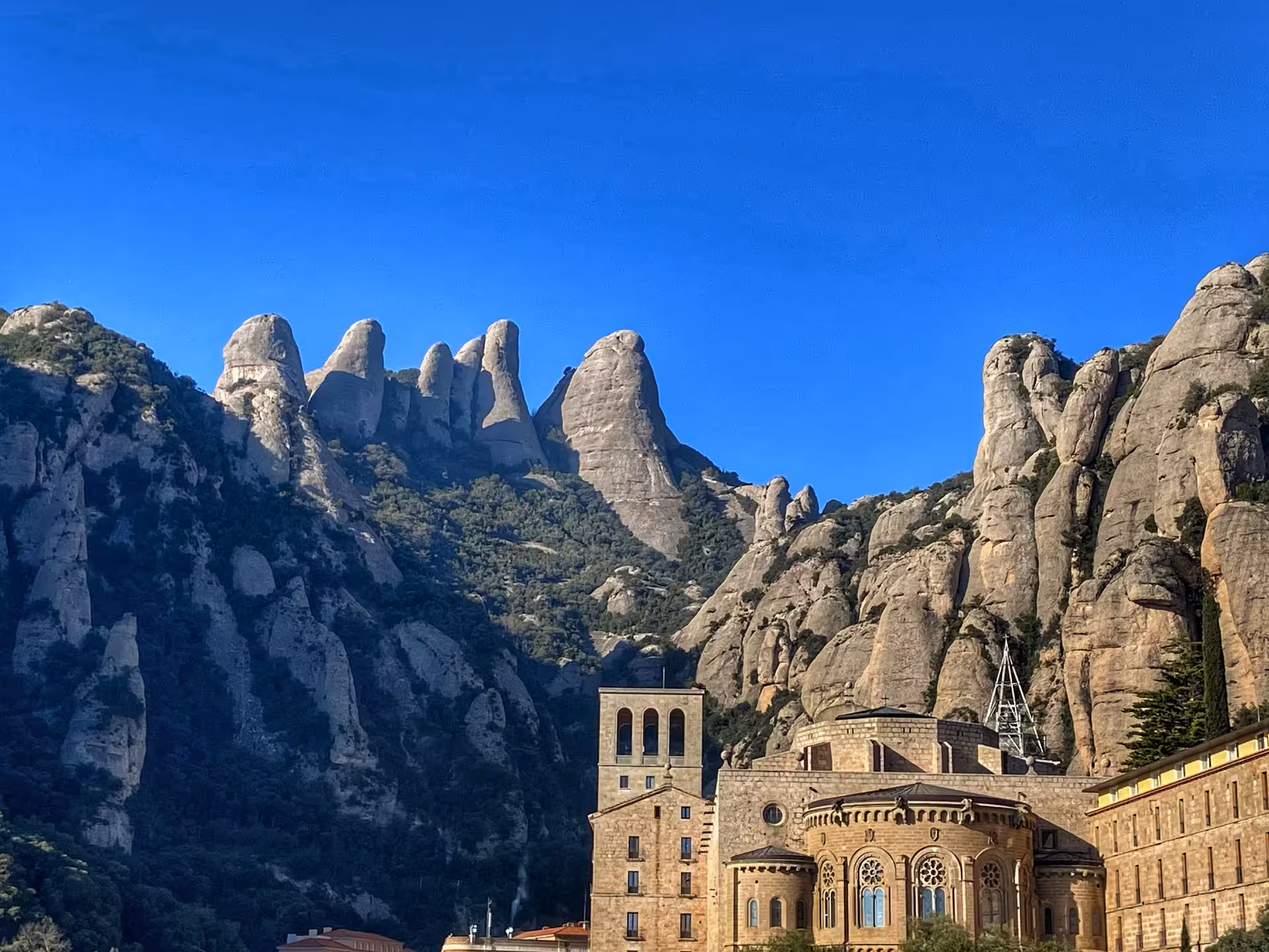 Montserrat Basilica and monastery framed by iconic rock spires, visited on a private vehicle tour from Barcelona