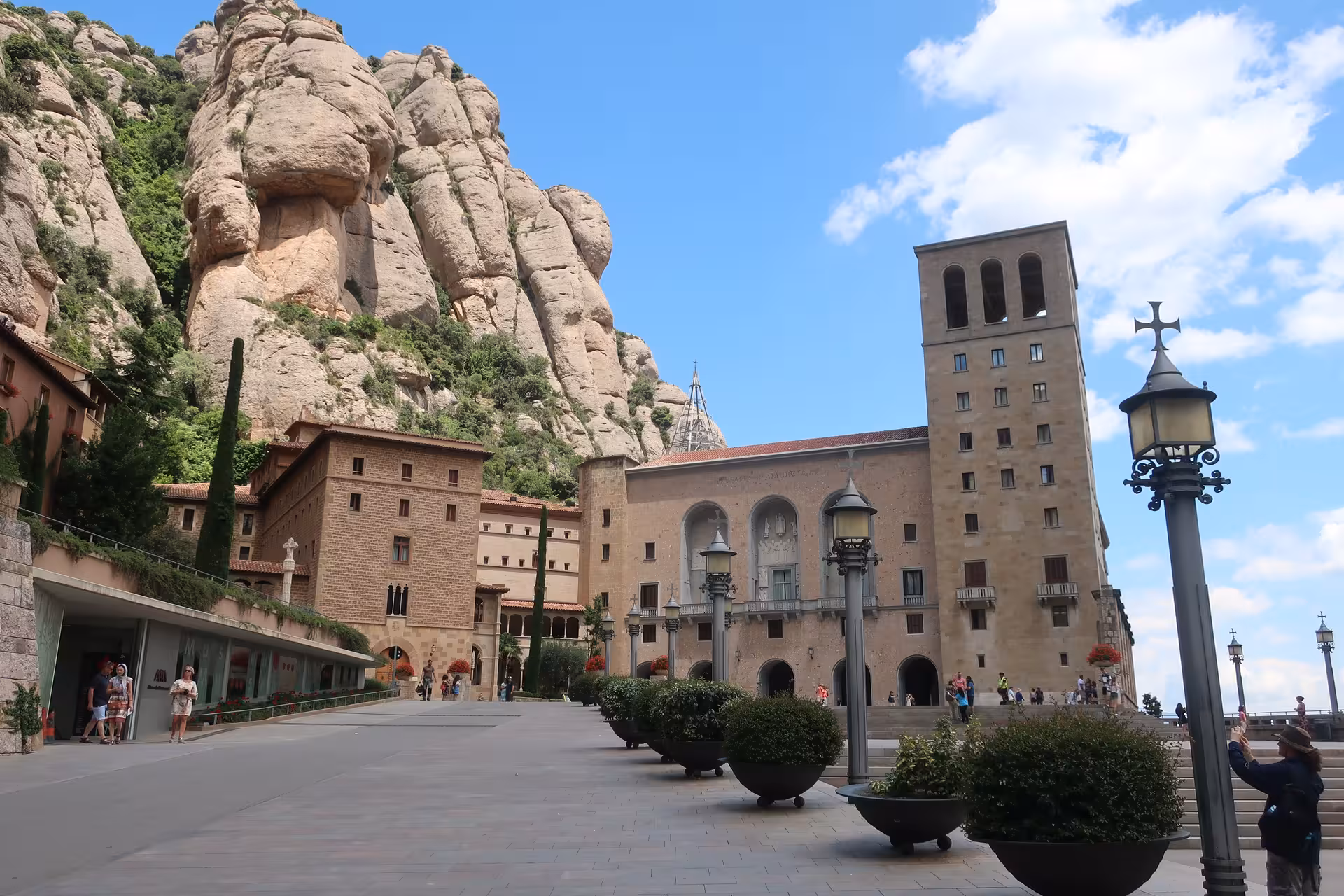 Montserrat Monastery plaza and basilica beneath jagged peaks on a private half-day tour from Barcelona