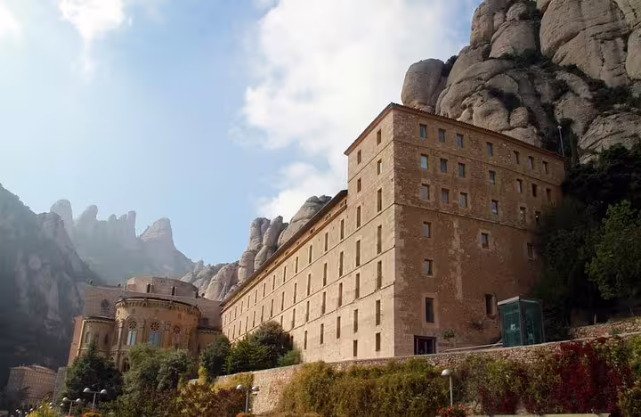 Scenic view of Montserrat Monastery nestled in rocky mountains, perfect for a private tour with lunch and wine tasting in Penedes.