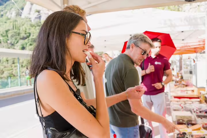 Tour participants tasting local products at a market stall during the Montserrat farmhouse tour.