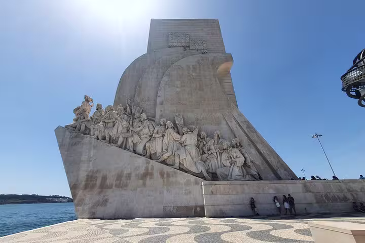 Monument of Discoveries in Belem, Lisbon, under clear blue sky, highlighting historical explorers on a private full-day tour.