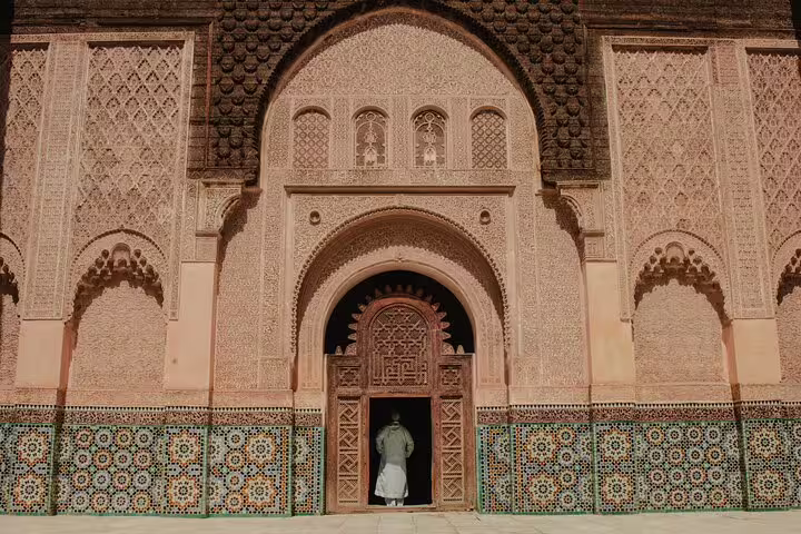 Intricate Moorish arch and zellige tiles at a Moroccan medina mosque, cultural stop on 12-day tour from Casablanca