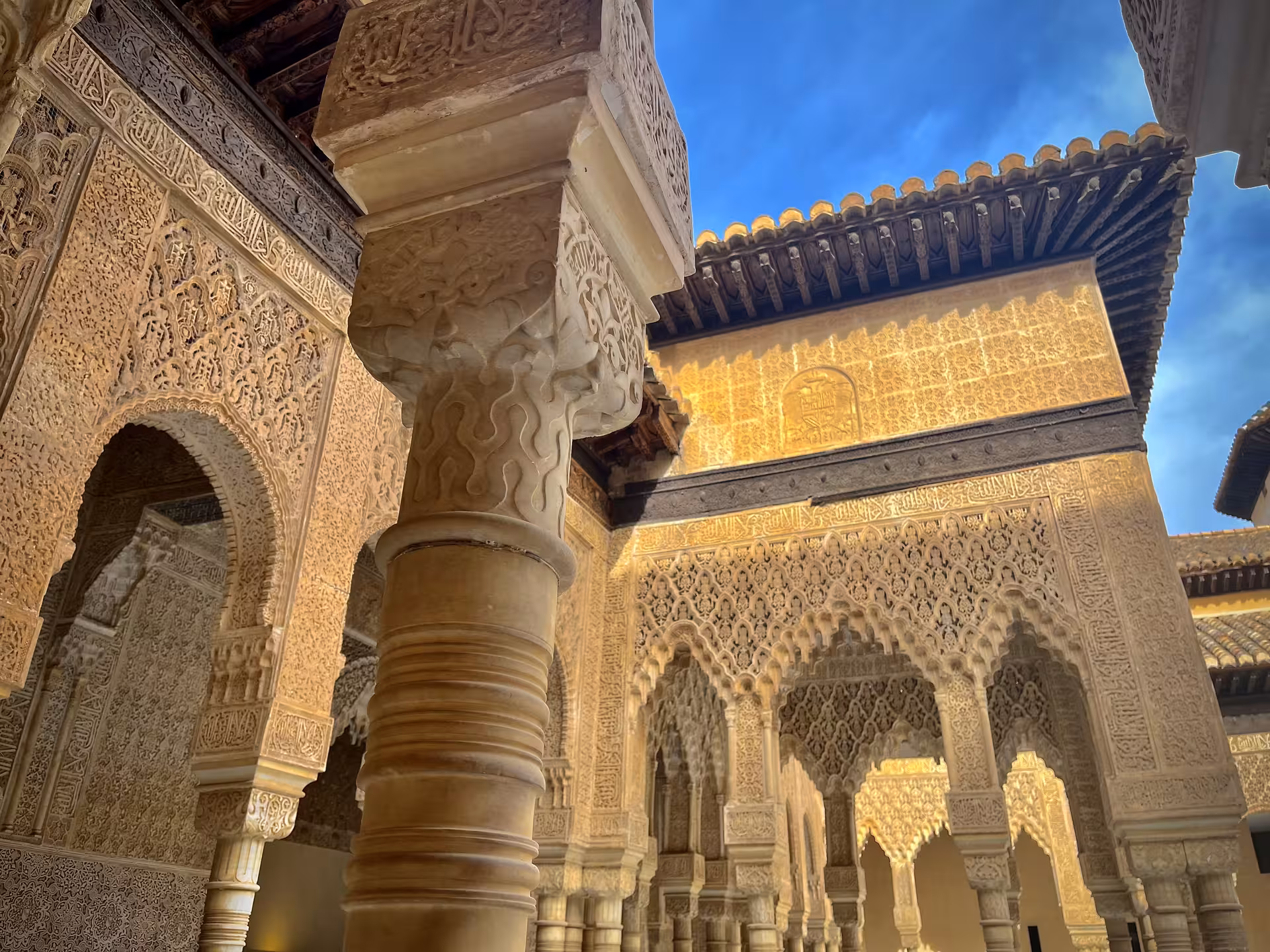 Intricate Moorish arches and carved columns in Alhambra, Granada, on Encantos Locales + Alhambra tour